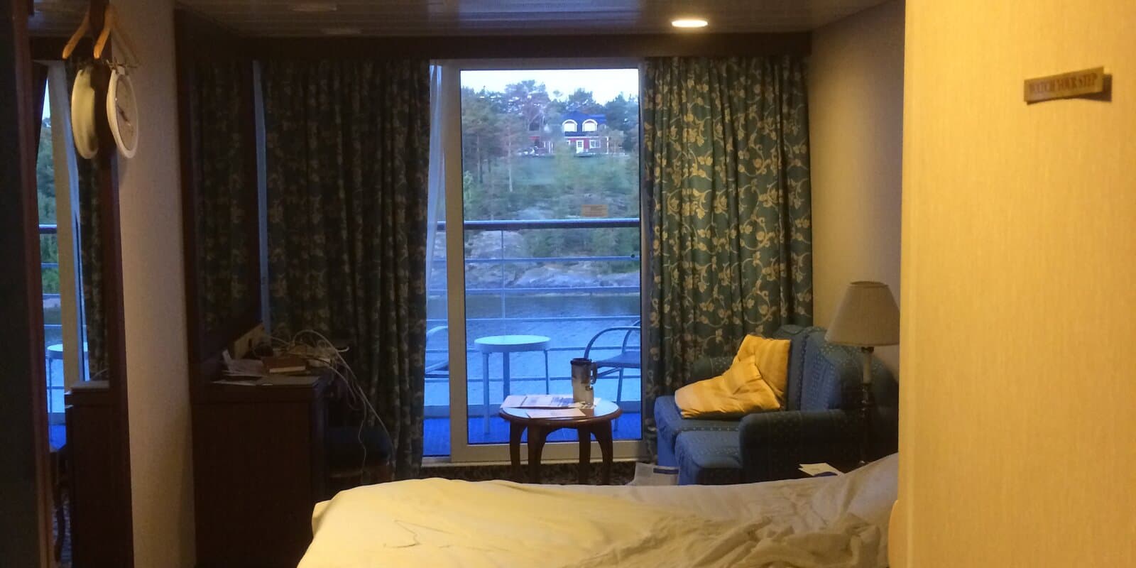 Cruise ship balcony stateroom with table and chairs on the private veranda
