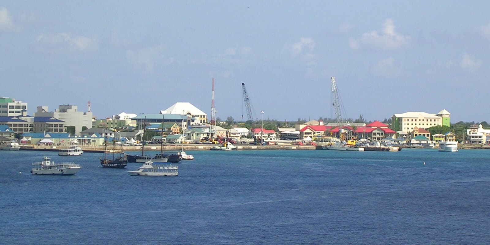 George Town harbor in Grand Cayman with small boats on turquoise water and waterfront buildings