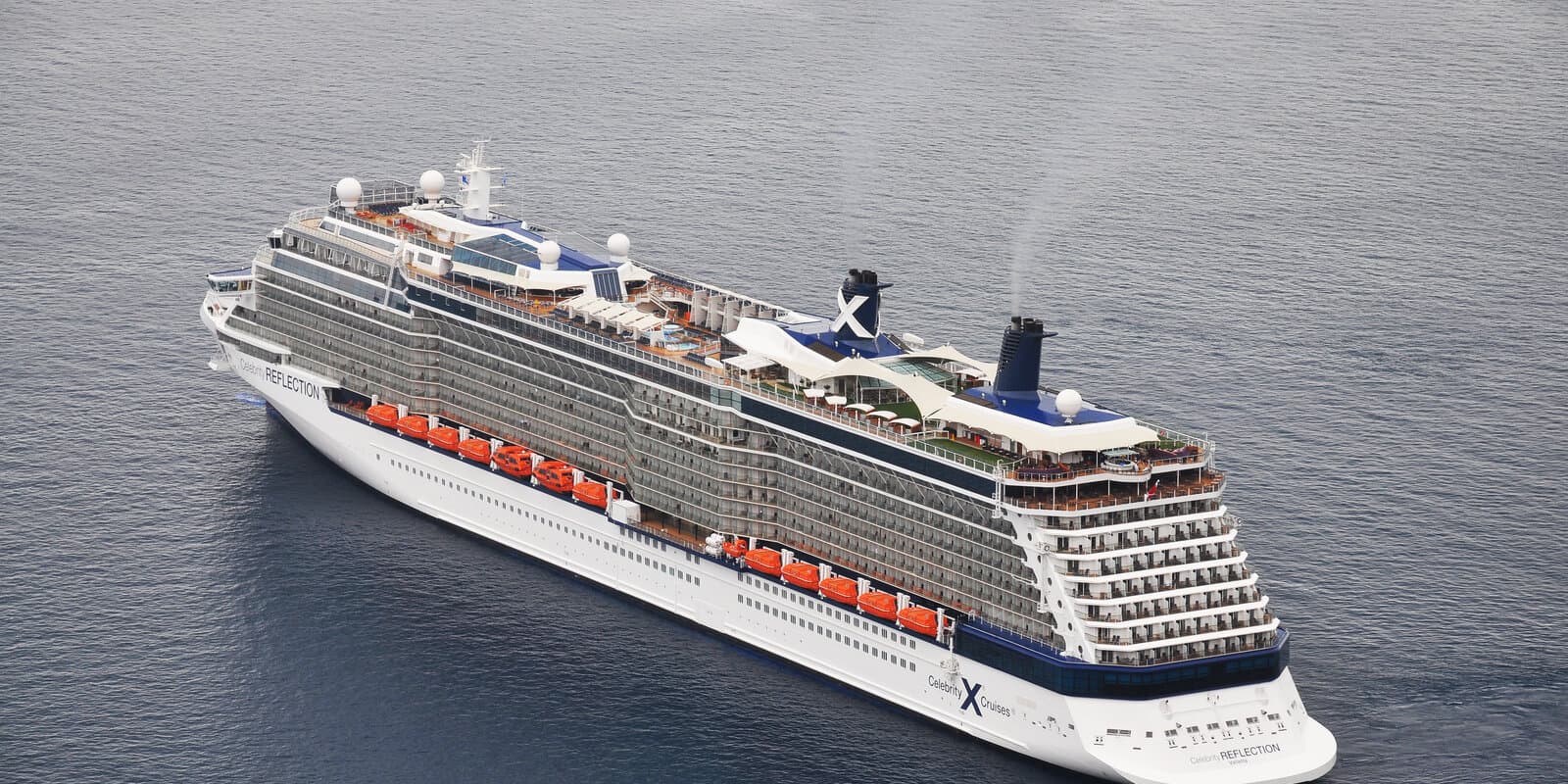 Celebrity Reflection cruise ship viewed from above at sea with Celebrity X branding on the hull and funnel