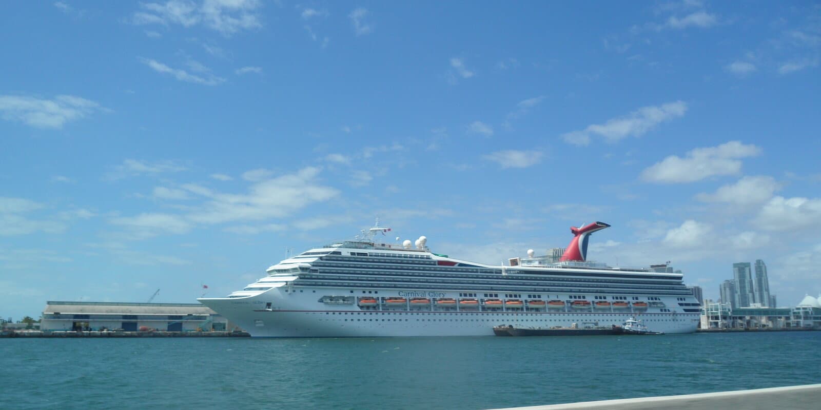 Carnival Glory cruise ship docked at Port Miami with the pier and downtown skyline visible