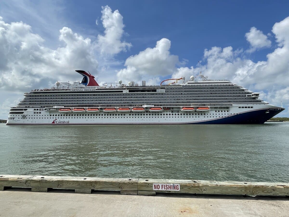 Carnival cruise ship departing the Port of Galveston with the harbor and causeway in view