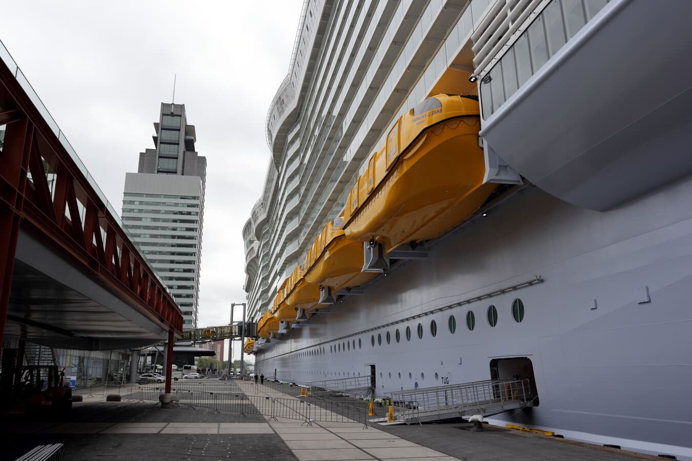 Harmony of the Seas at the Rotterdam cruise terminal pier, full Oasis-class profile visible from dockside