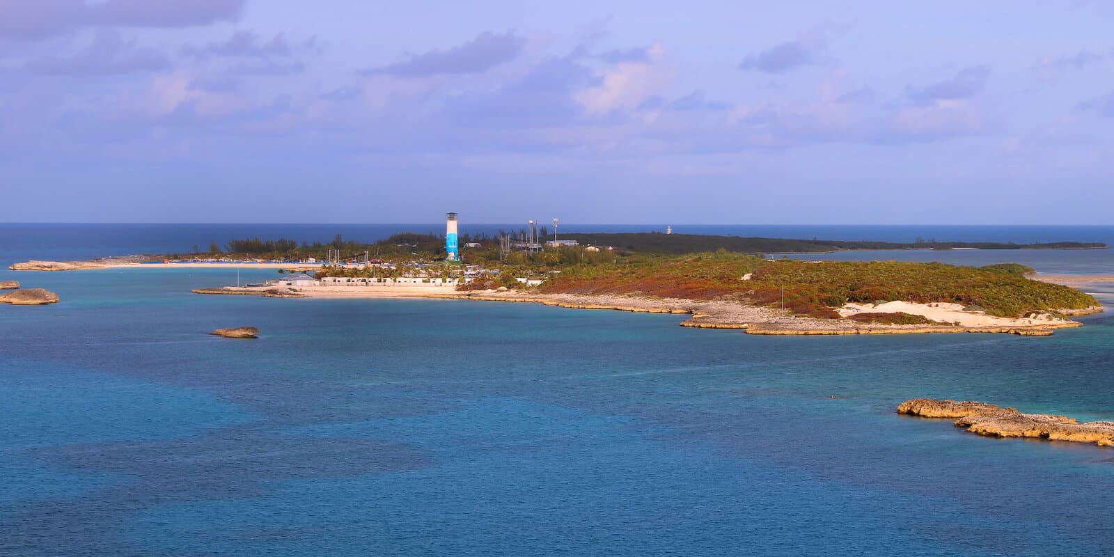 Aerial view of Great Stirrup Cay shoreline in the Bahamas with turquoise water and low island vegetation