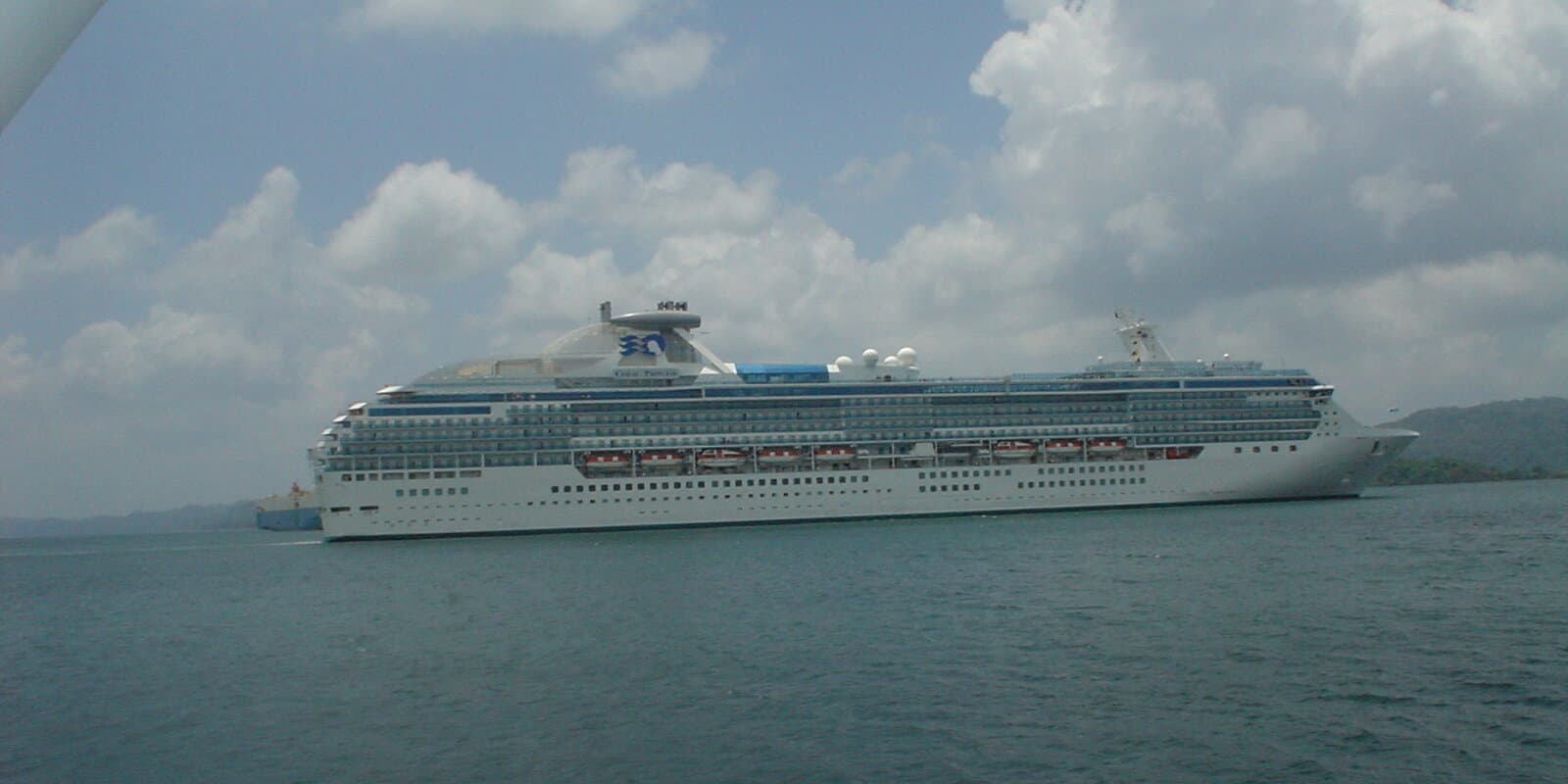 Cruise ship in a Panama Canal lock with water on both sides and canal walls visible