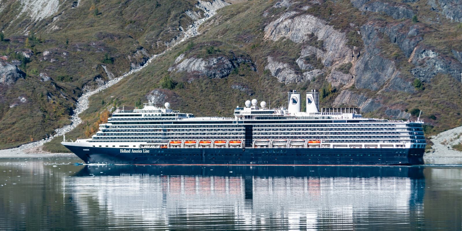Cruise ship in Glacier Bay Alaska with mountains and ice