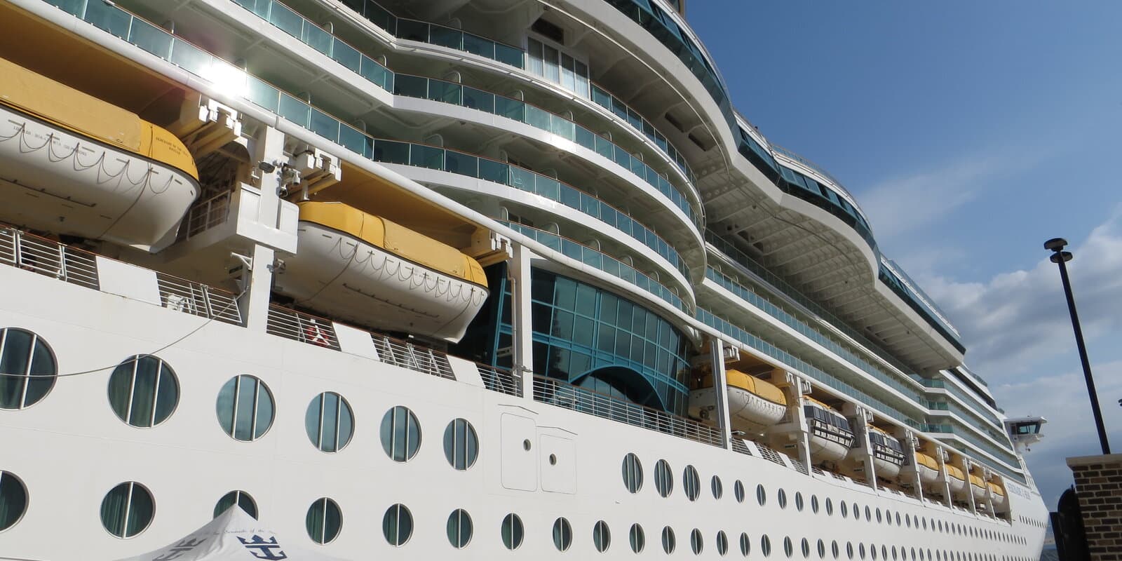 Royal Caribbean cruise ship Serenade of the Seas docked at the tropical port of Falmouth, Jamaica, with palm trees and blue Caribbean water