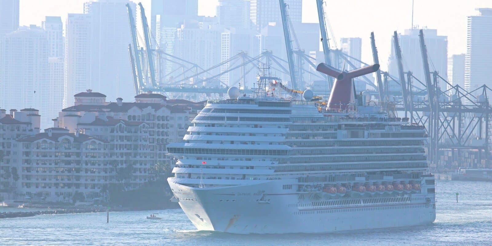 Carnival Magic departing PortMiami with the Miami skyline and cruise terminals in the background