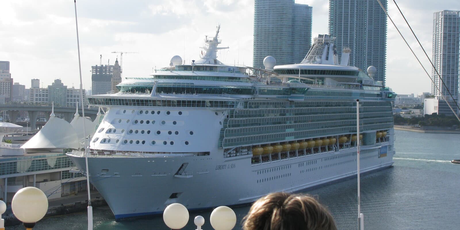 Liberty of the Seas cruise ship docked at the Port of Miami, with the ship name visible on the hull