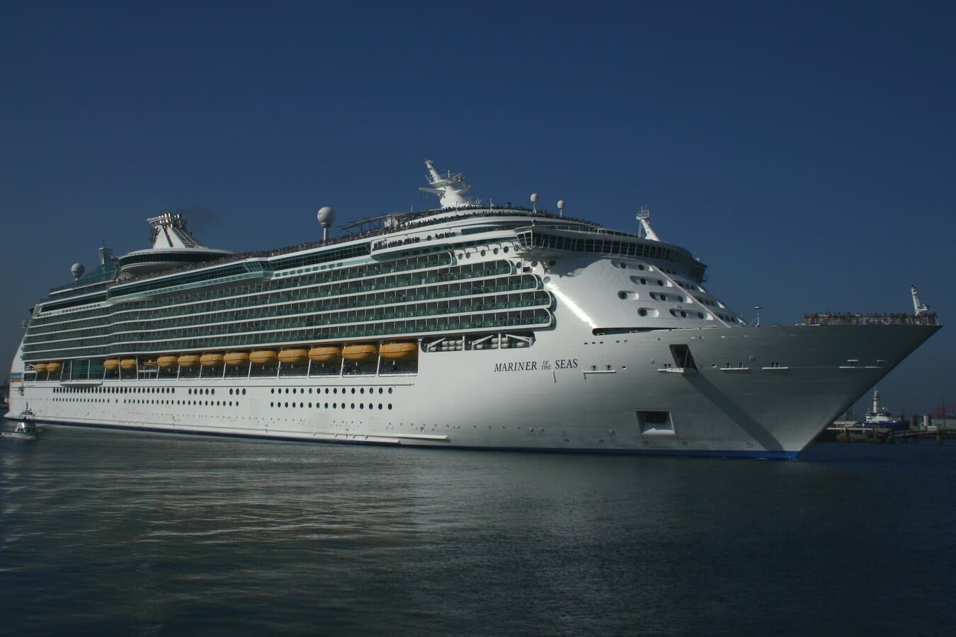 Royal Caribbean cruise ship Mariner of the Seas departing San Pedro Harbor, Los Angeles, with harbor cranes and hills in the background
