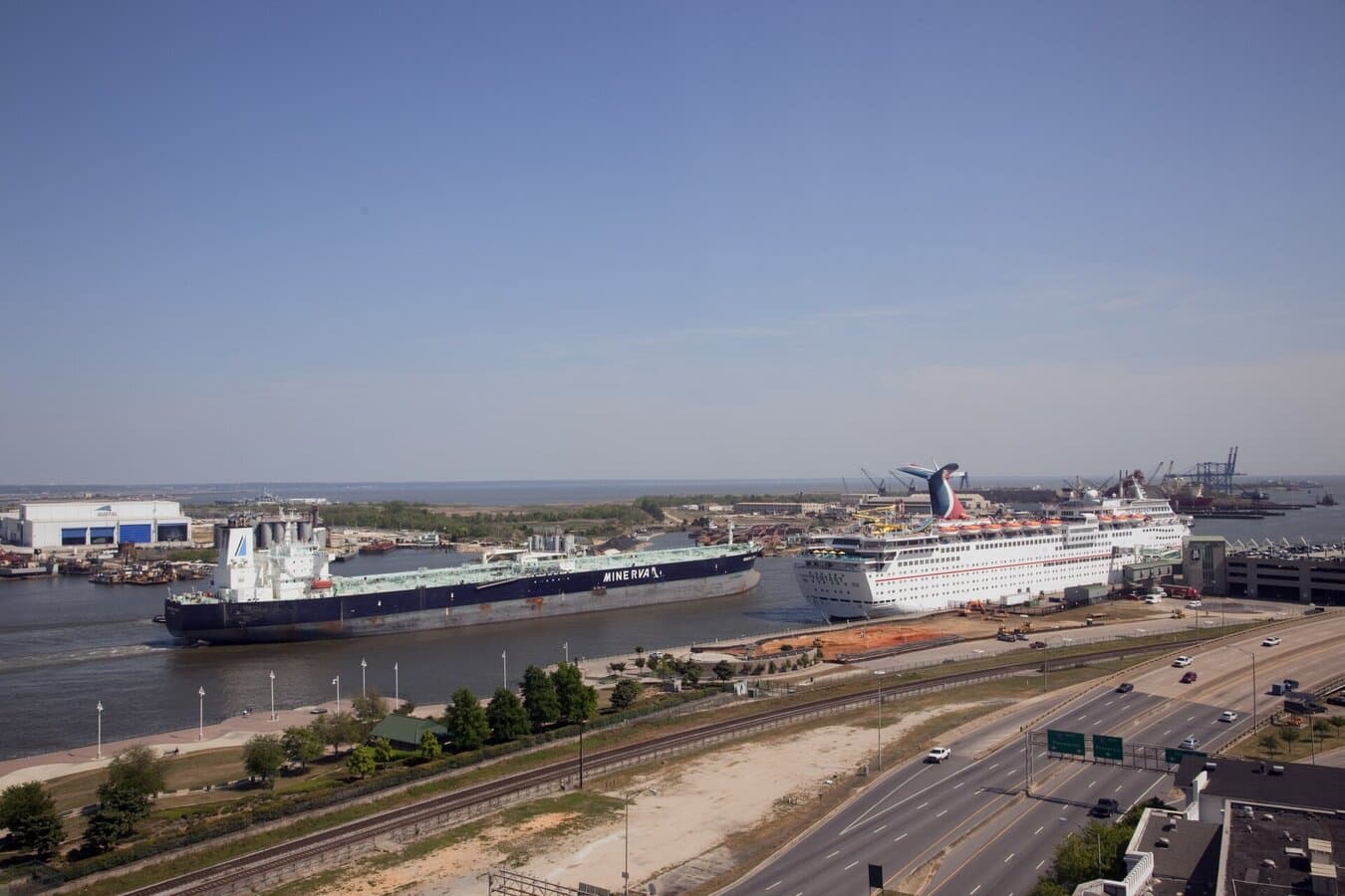 Cruise ships on the Mobile River harbor with the Alabama Cruise Terminal and downtown Mobile in the background
