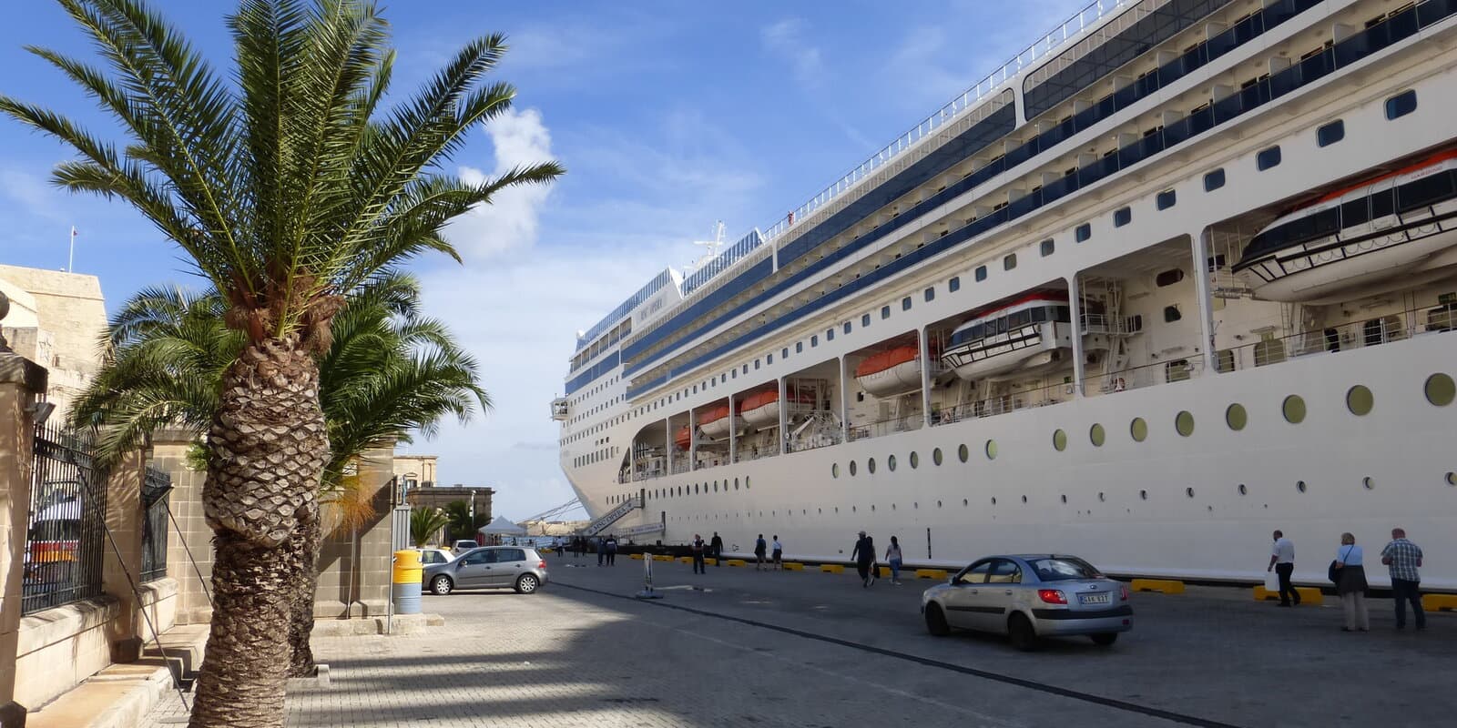 MSC Opera moored at Valletta harbor with MSC funnel branding visible and the ship name on the hull