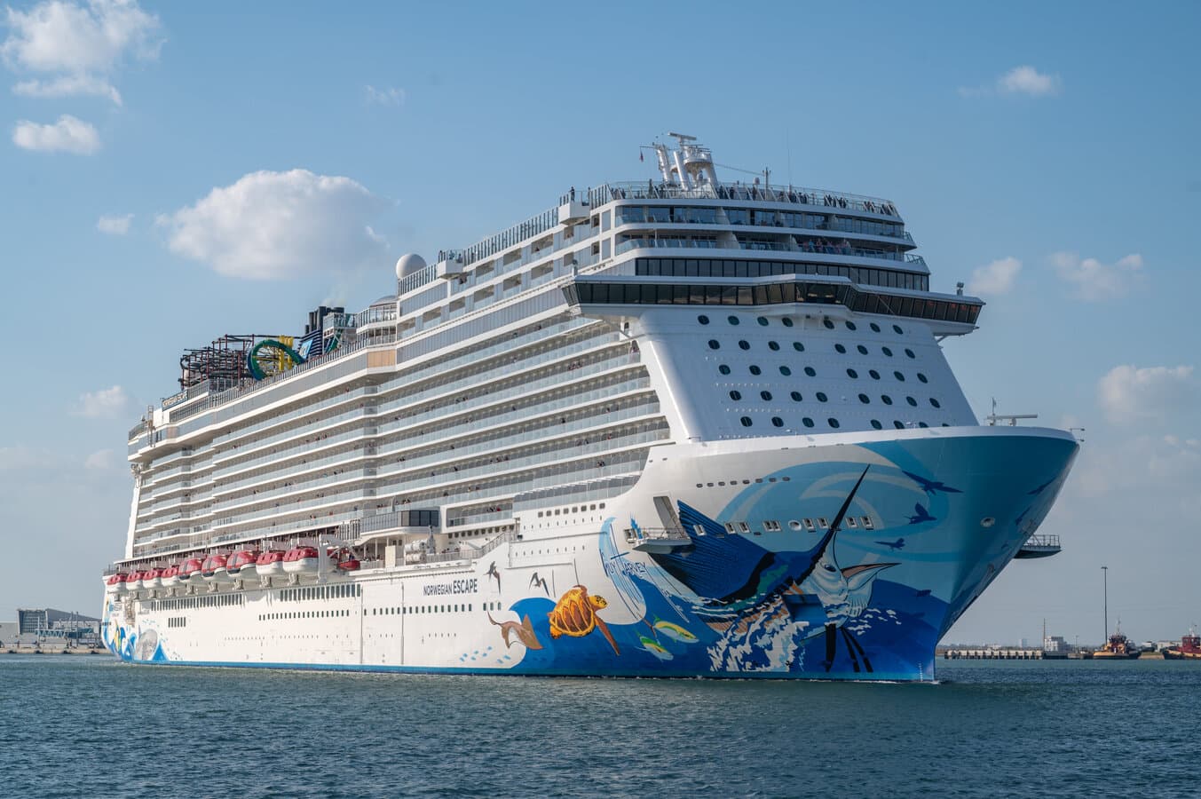 Norwegian Escape cruise ship with Guy Harvey hull art on blue water