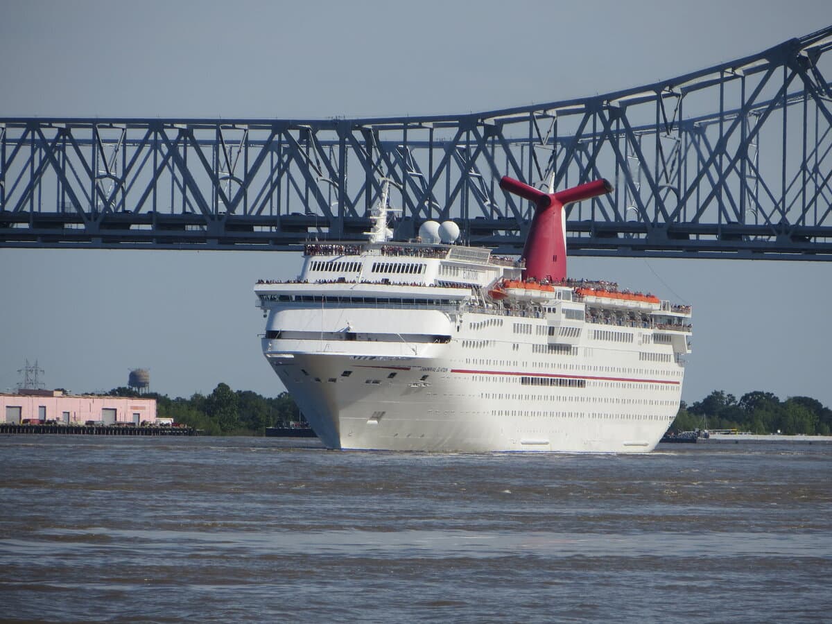 Carnival Elation departing the Port of New Orleans cruise terminal with the Crescent City Connection bridge spanning the Mississippi River