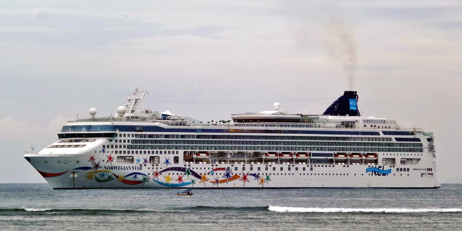 Norwegian Star cruise ship profile at sea with hull art, NCL funnel, and ship name on the hull
