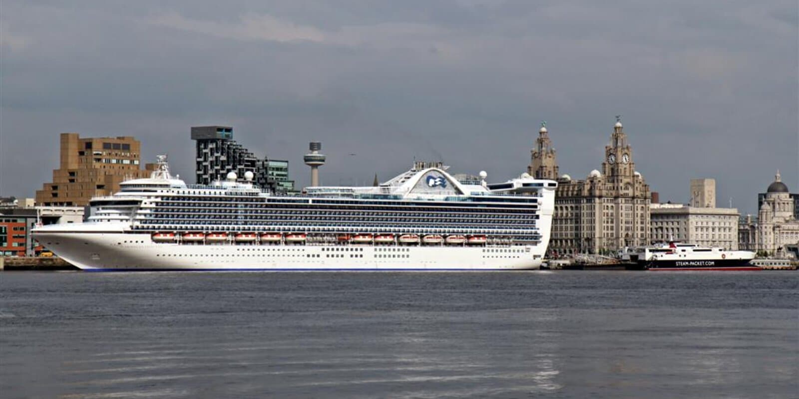 Caribbean Princess cruise ship docked at Liverpool cruise terminal, with Princess sea witch logo visible on the white hull and funnel