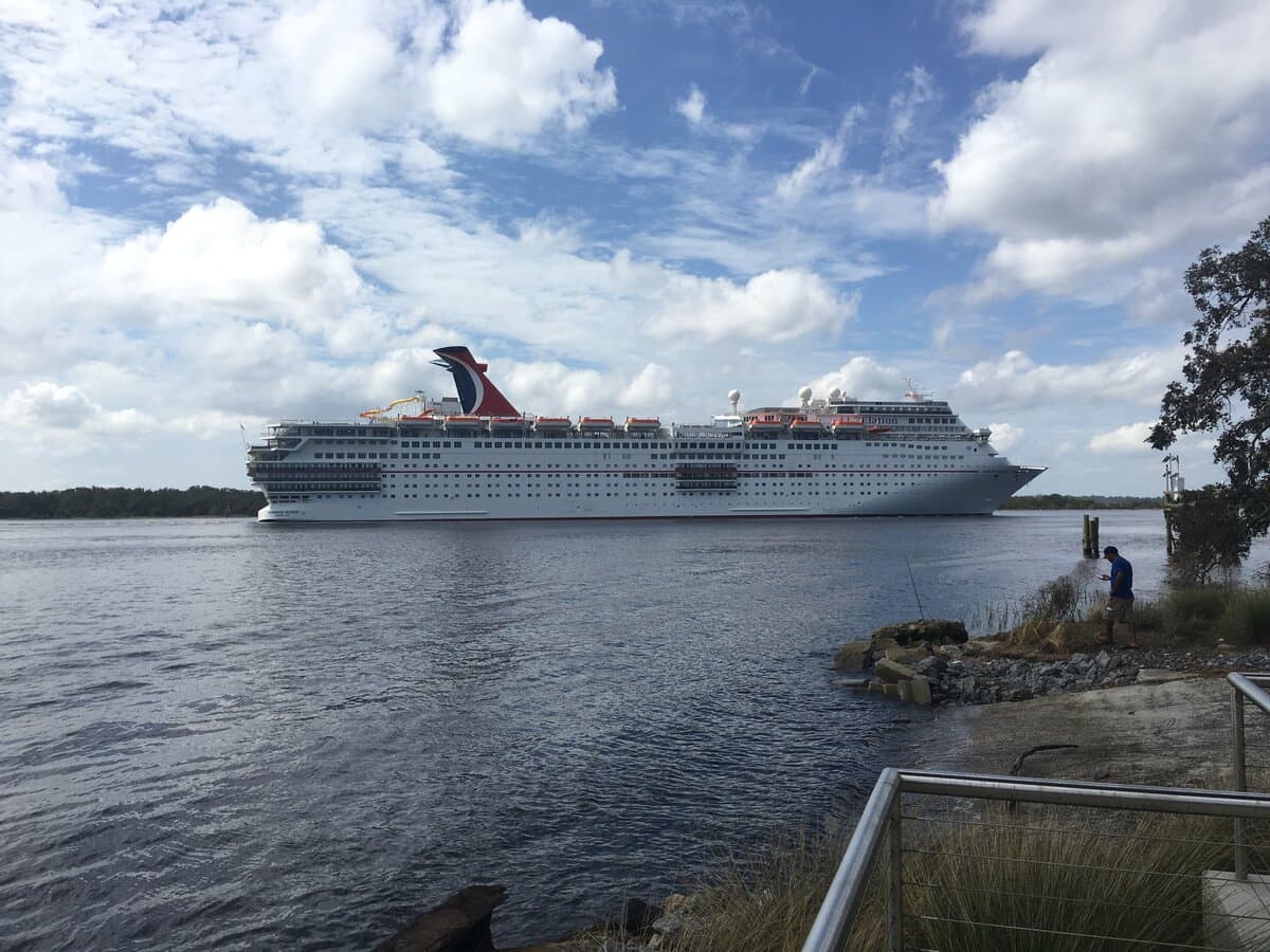 Carnival Elation on the St. Johns River in Jacksonville, with the whale-tail funnel and Elation lettering visible on the hull