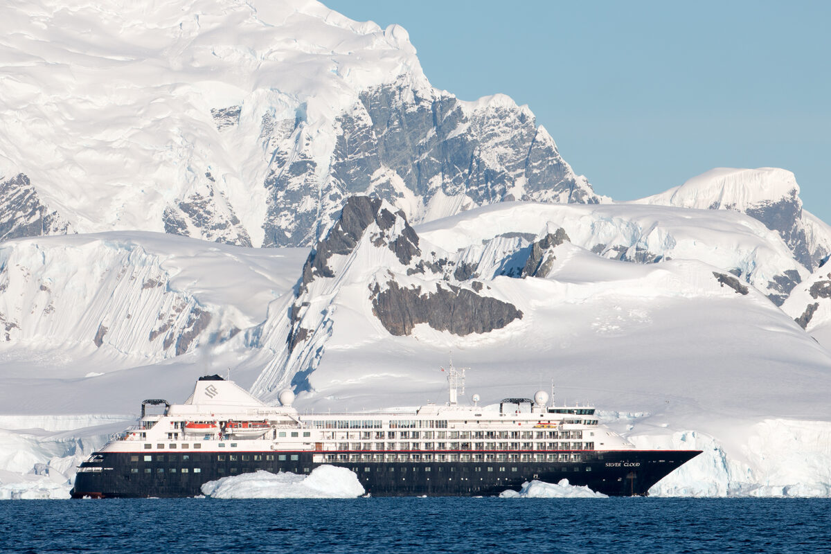 Silversea Silver Cloud expedition ship in Wilhelmina Bay, Antarctica with snowy peaks
