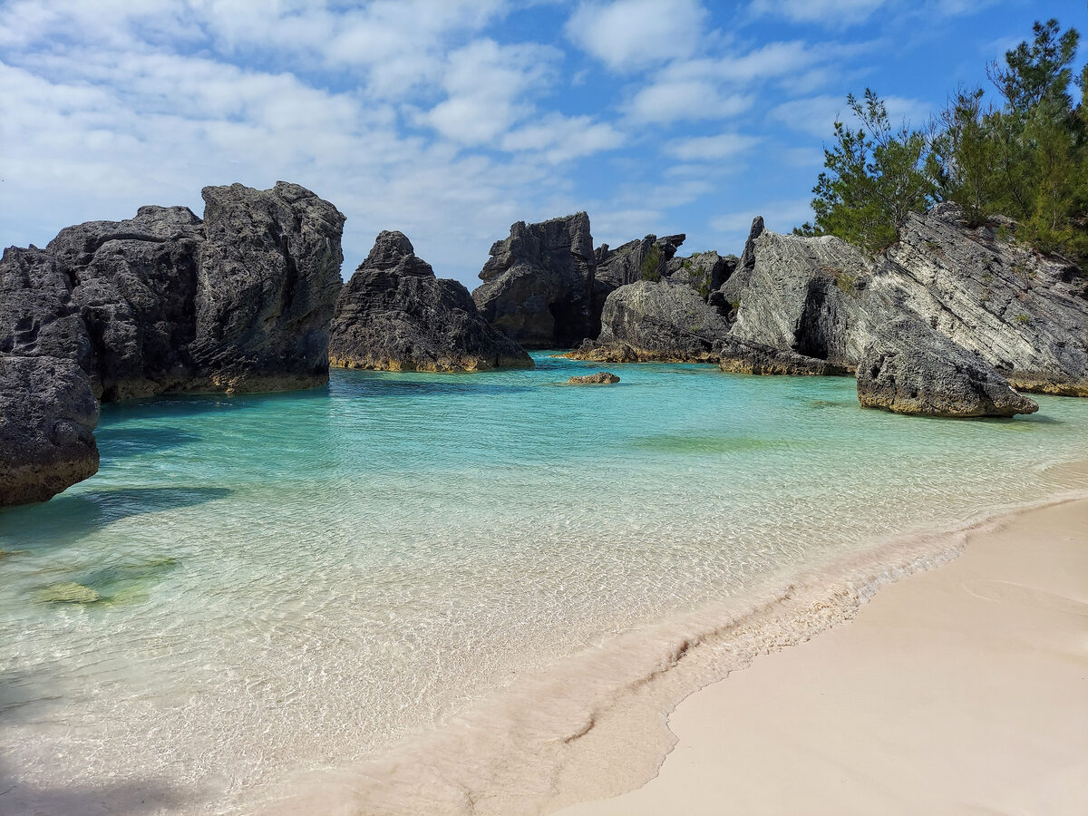 Horseshoe Bay Cove in Bermuda with pink sand beach and turquoise water between limestone cliffs
