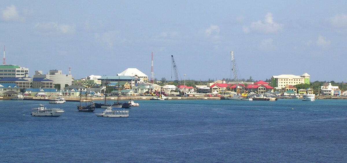 George Town harbour in Grand Cayman viewed from a cruise ship, with tender boats and waterfront buildings along the shore