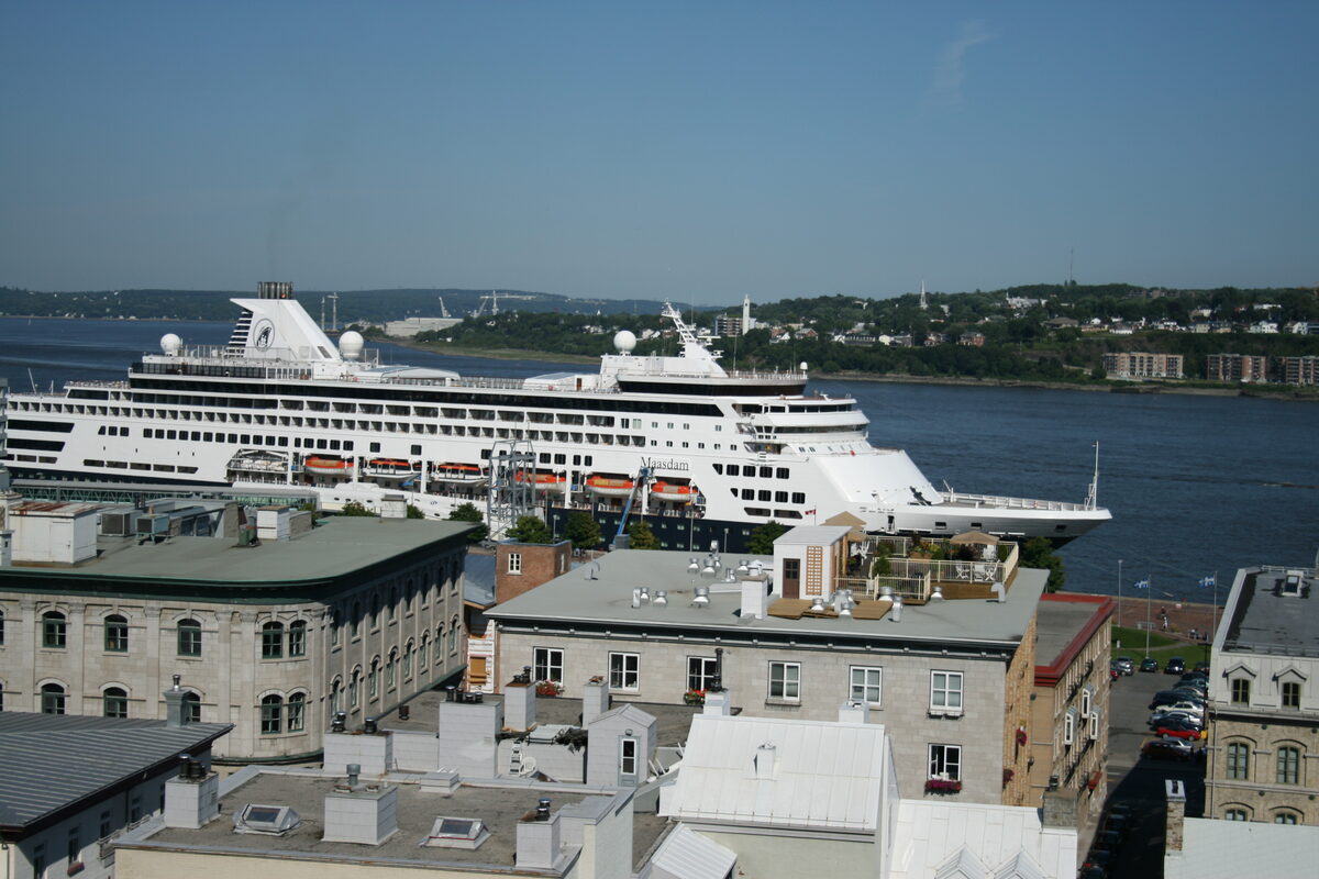 Holland America cruise ship MS Maasdam docked in Quebec City with historic stone rooftops in the foreground