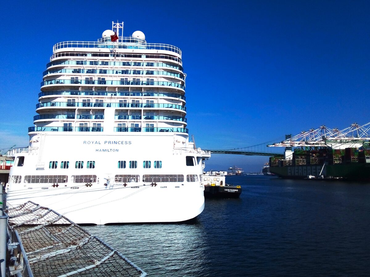 Royal Princess cruise ship docked at the Los Angeles World Cruise Center in San Pedro with the Vincent Thomas Bridge visible in the background