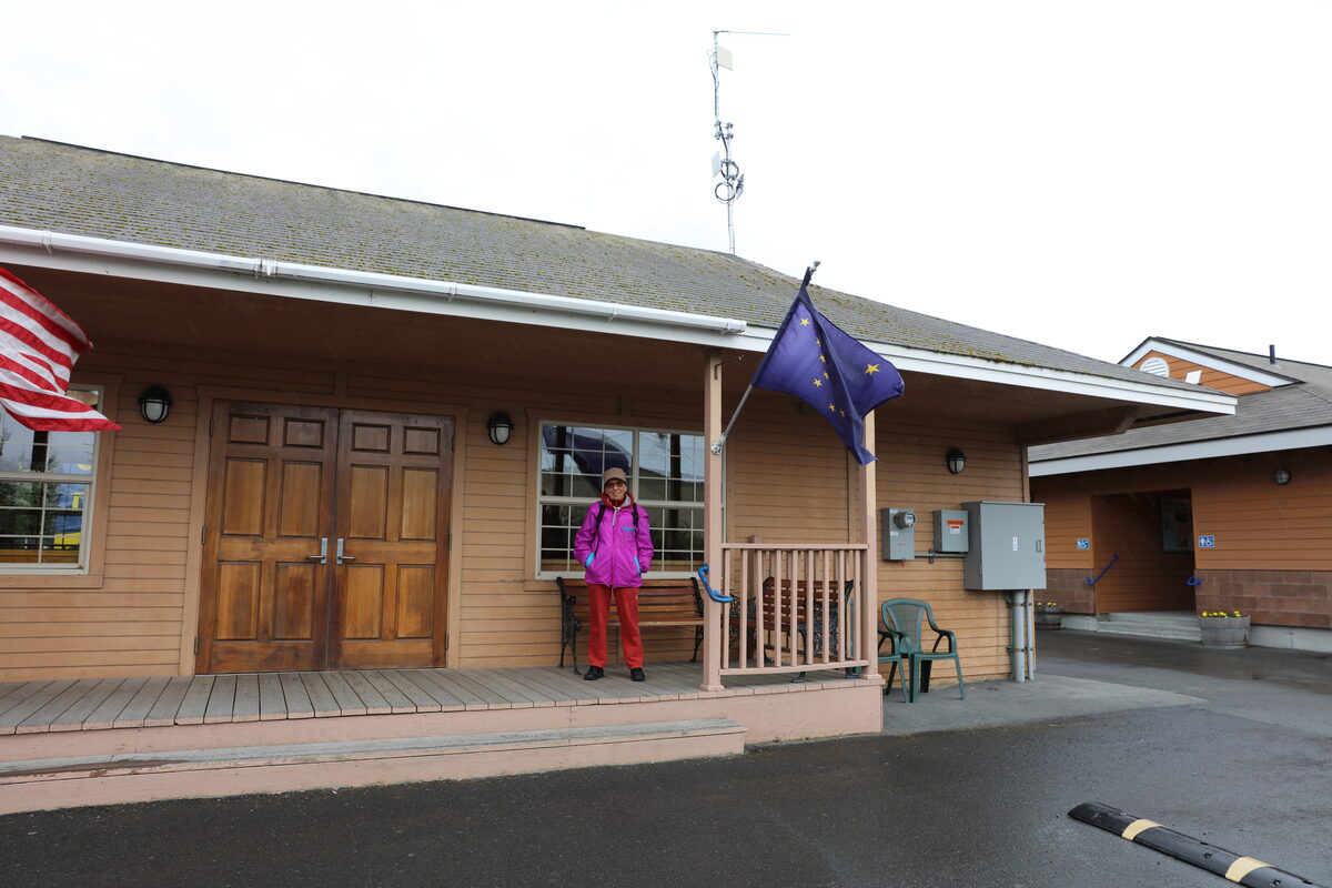 The Alaska Railroad depot building in Seward, a low wooden station with the Alaska state flag on the porch