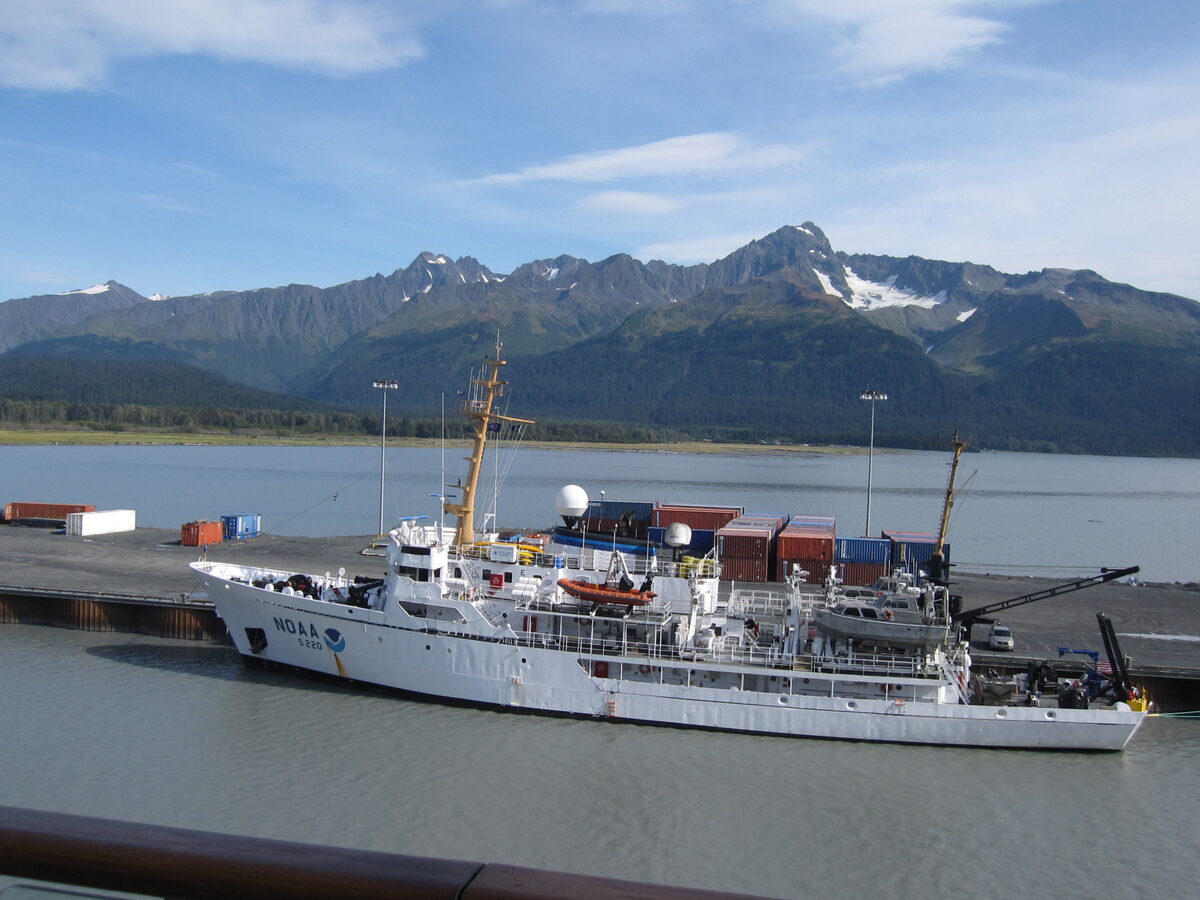 NOAA research vessel Fairweather docked at Seward, Alaska with snow-capped Kenai Peninsula mountains in the background